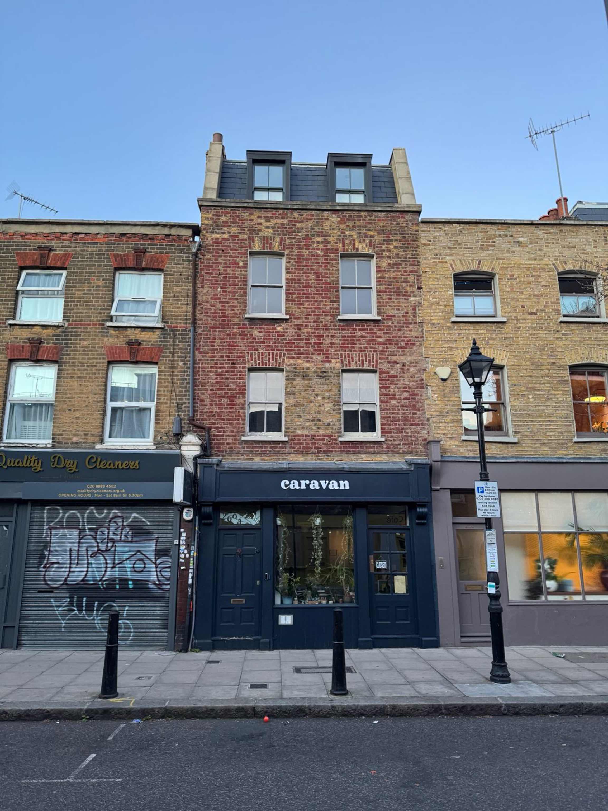 The Caravan shop front: navy paintwork and the caravan sign in a red-brick terrace on Globe Road